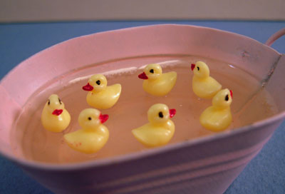 1" scale miniature Karen Aird baby ducks swimming in a tube of water 1" scale miniature Karen Aird baby ducks swimming in a tube of water